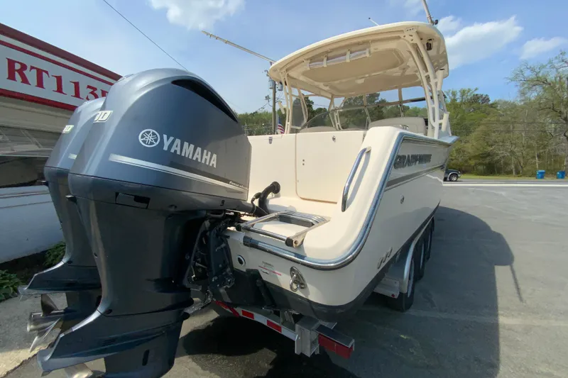 Slide: The Image of 2017 Grady-White Freedom 307 boat with Yamaha engines, parked outdoors. - 10