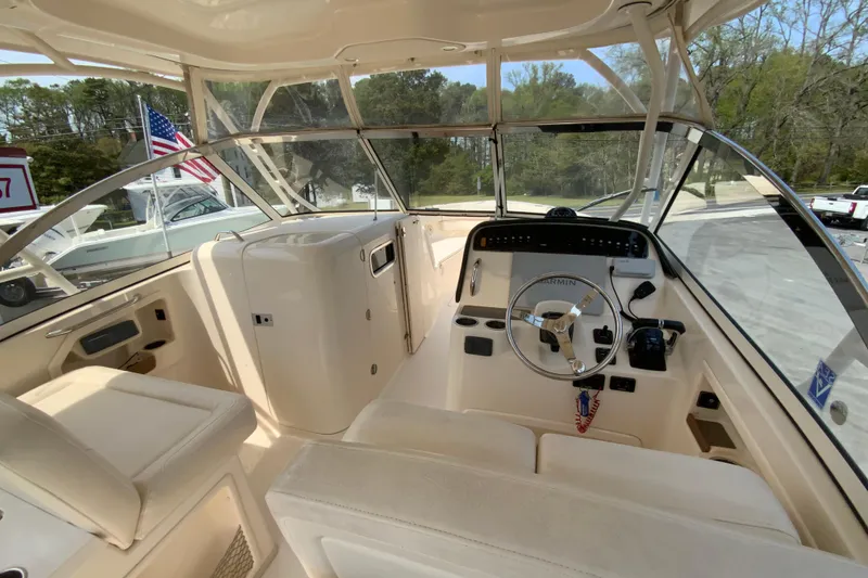 Slide: The Image of 2017 Grady-White Freedom 307 boat interior with steering wheel and seating area. - 12