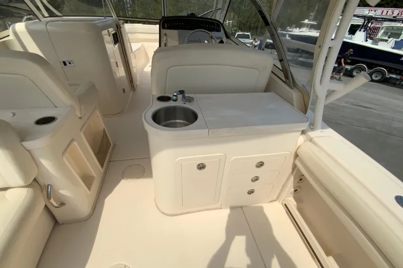 Slide: The Image of 2017 Grady-White Freedom 307 boat interior with sink and storage compartments. - 18