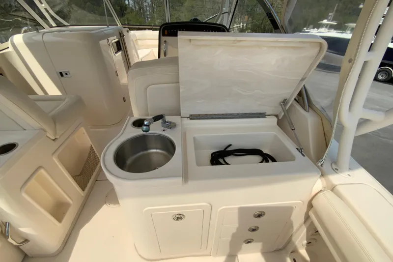 Slide: The Image of 2017 Grady-White Freedom 307 boat interior with sink and storage compartments. - 19