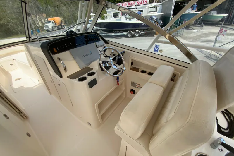 Slide: The Image of 2017 Grady-White Freedom 307 boat interior with steering wheel and Garmin display. - 20