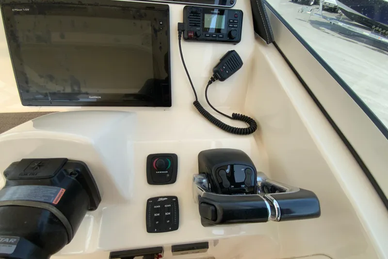 Slide: The Image of 2017 Grady-White Freedom 307 boat dashboard with Garmin display and controls. - 23
