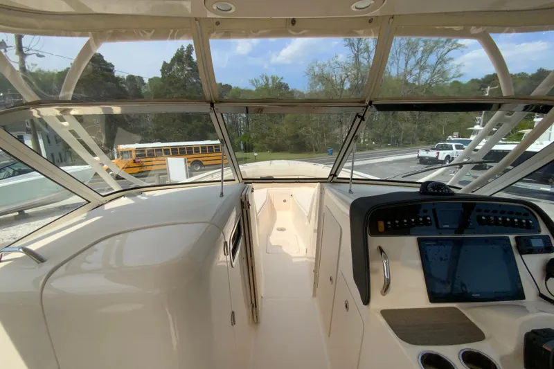 Slide: The Image of Interior view of 2017 Grady-White Freedom 307 boat cockpit with dashboard controls. - 26