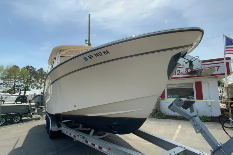 Slide: The Image of 2017 Grady-White Freedom 307 boat on trailer, parked outdoors. - 3