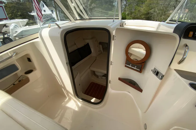 Slide: The Image of 2017 Grady-White Freedom 307 boat interior with cabin door and seating area. - 31