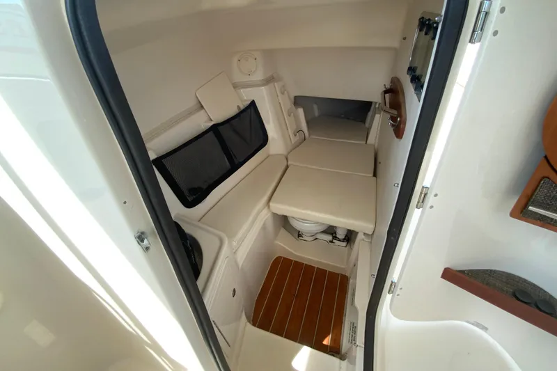 Slide: The Image of 2017 Grady-White Freedom 307 cabin interior with seating and wooden flooring. - 32