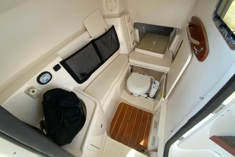 Slide: The Image of Interior cabin of 2017 Grady-White Freedom 307 boat with seating and marine toilet. - 33