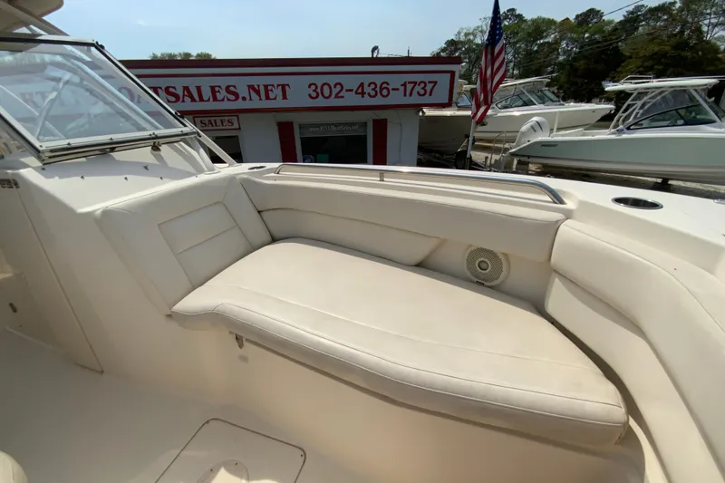 Slide: The Image of 2017 Grady-White Freedom 307 boat interior with cushioned seating and dealership in background. - 35