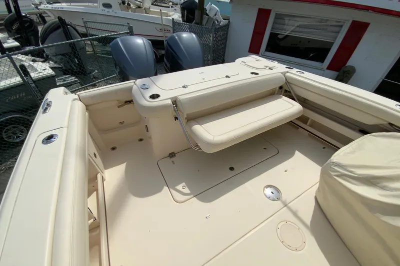 Slide: The Image of 2017 Grady-White Freedom 307 boat interior with seating and dual outboard motors. - 38