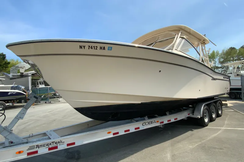 Slide: The Image of 2017 Grady-White Freedom 307 boat on trailer, parked outdoors. - 5
