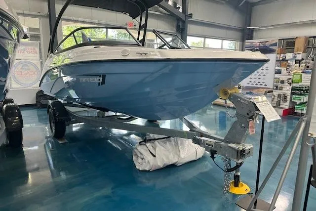 Slide: The Image of 2025 Yamaha Boats AR190 displayed in a showroom on a trailer. - 14