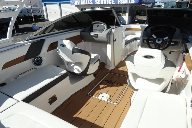 Slide: The Image of 2023 Chaparral 23 Surf boat interior with modern seating and sleek dashboard design. - 18