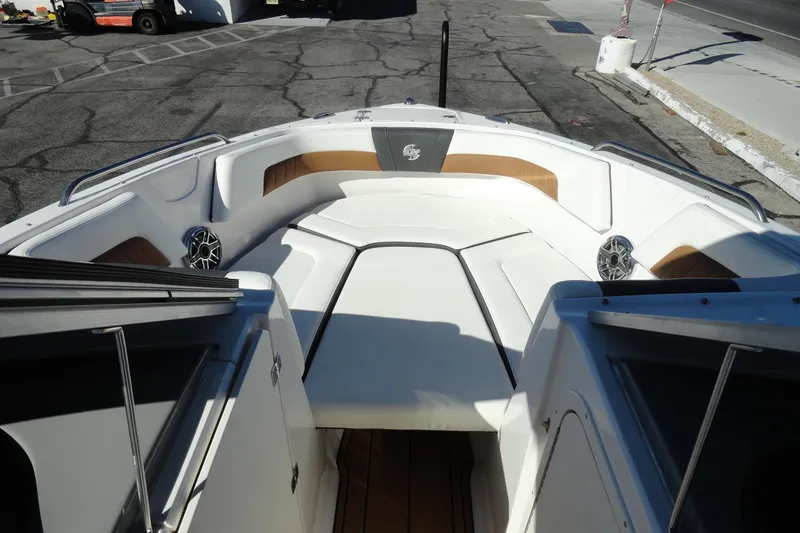 Slide: The Image of 2023 Chaparral 23 Surf boat interior with white seating and speakers. - 21