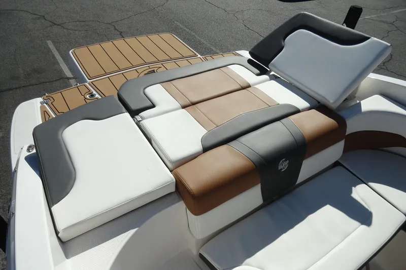 Slide: The Image of 2023 Chaparral 23 Surf boat with luxurious tan and white seating. - 25