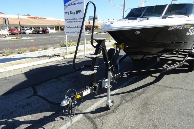 Slide: The Image of 2023 Chaparral 23 Surf boat on trailer in parking lot near RV dealership. - 29
