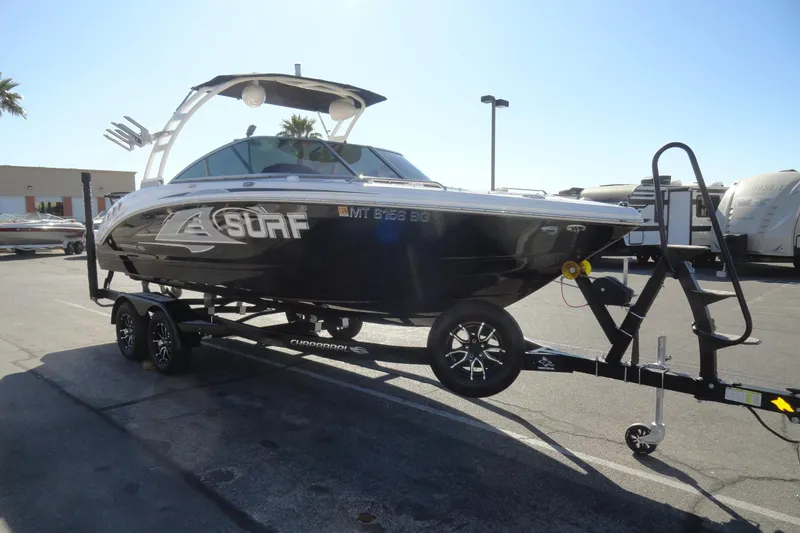 Slide: The Image of 2023 Chaparral 23 Surf boat on trailer in parking lot, sunny day. - 4