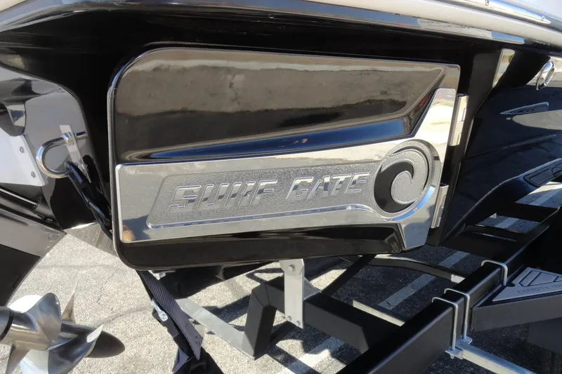 Slide: The Image of 2023 Chaparral 23 Surf boat with "Surf Gate" feature, showcasing sleek design. - 8