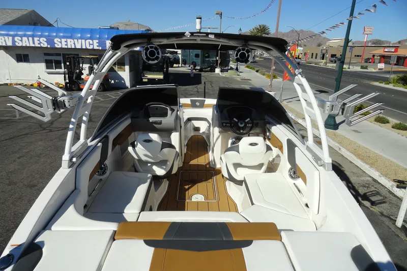 Slide: The Image of 2023 Chaparral 23 Surf boat interior with sleek seating and modern dashboard. - 9