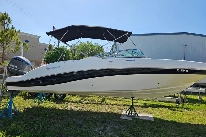 Slide: The Image of 2016 Hurricane SunDeck 2690 OB boat with canopy on display outdoors. - 10