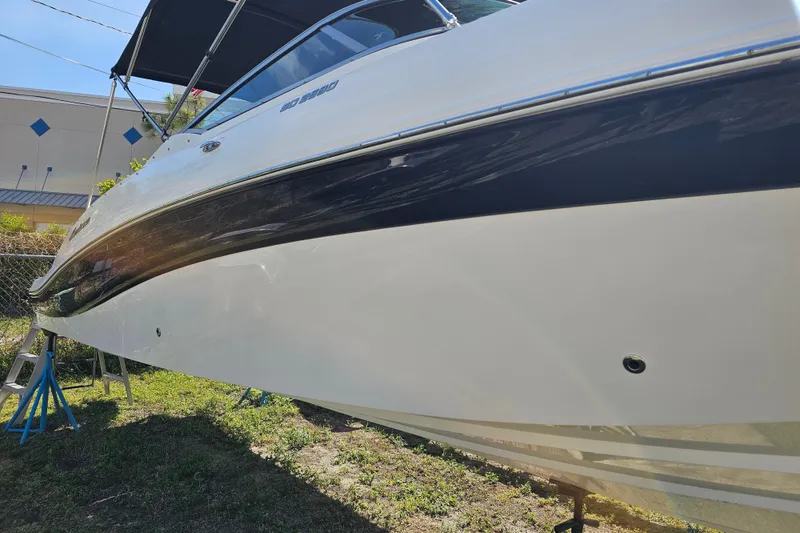 Slide: The Image of 2016 Hurricane SunDeck 2690 OB boat on stands, side view. - 11