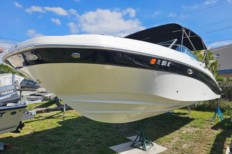 Slide: The Image of 2016 Hurricane SunDeck 2690 OB boat on display, featuring sleek design and black accents. - 12