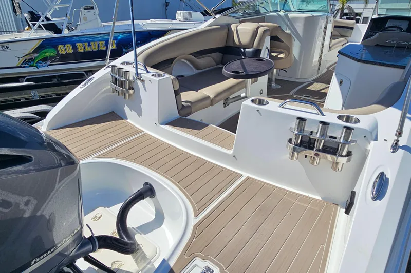 Slide: The Image of 2016 Hurricane SunDeck 2690 OB boat interior with seating and cup holders. - 17