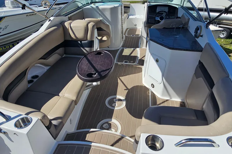 Slide: The Image of 2016 Hurricane SunDeck 2690 OB boat interior with beige seating and sleek design. - 18