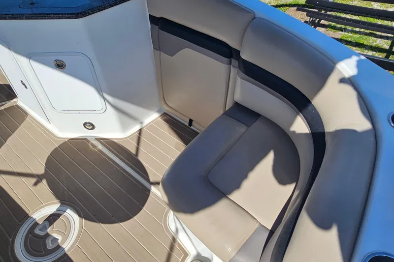 Slide: The Image of 2016 Hurricane SunDeck 2690 OB boat interior with cushioned seating and storage compartment. - 20