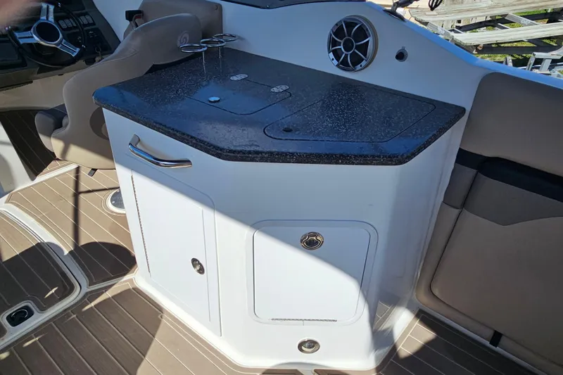 Slide: The Image of 2016 Hurricane SunDeck 2690 OB boat interior with sleek countertop and storage cabinets. - 21