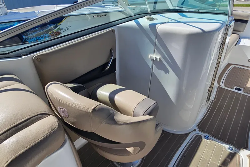 Slide: The Image of 2016 Hurricane SunDeck 2690 OB boat interior with beige seating and sleek design. - 23