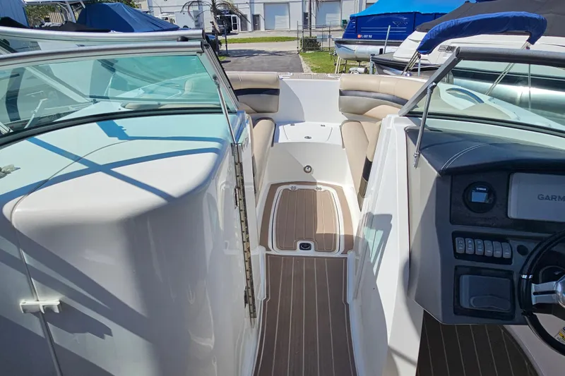 Slide: The Image of 2016 Hurricane SunDeck 2690 OB boat interior with seating and dashboard view. - 25