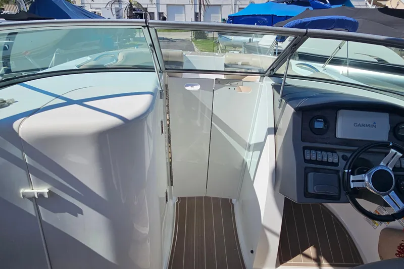 Slide: The Image of 2016 Hurricane SunDeck 2690 OB boat interior with Garmin navigation system and sleek design. - 26
