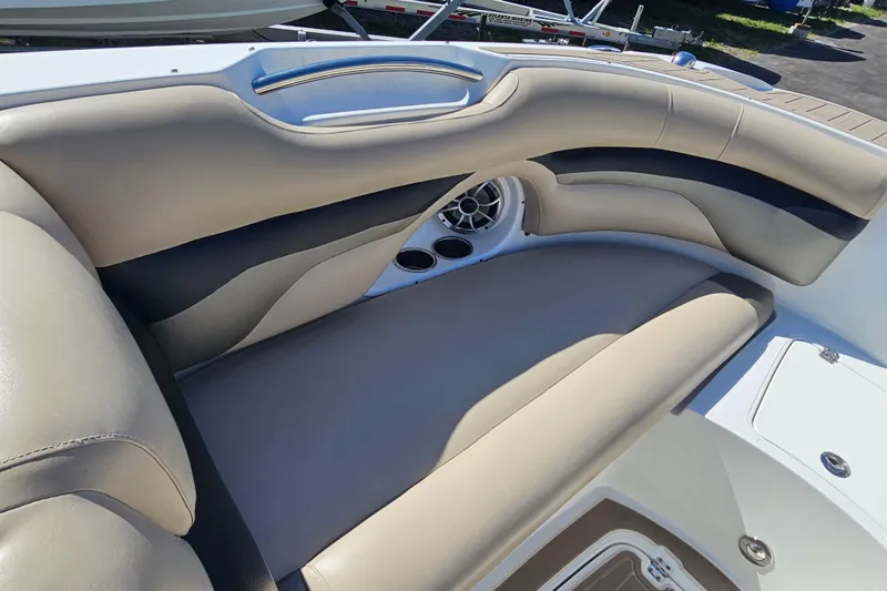 Slide: The Image of Luxurious seating on 2016 Hurricane SunDeck 2690 OB boat, featuring cup holders and speaker. - 28