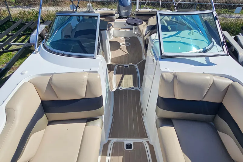 Slide: The Image of 2016 Hurricane SunDeck 2690 OB boat interior with beige seating and dual windshields. - 32