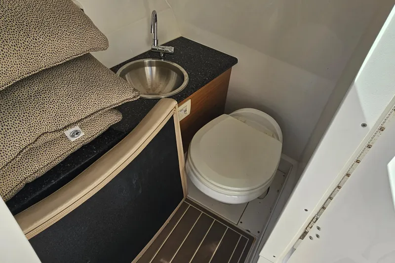 Slide: The Image of Interior of 2016 Hurricane SunDeck 2690 OB boat with toilet and sink. - 38