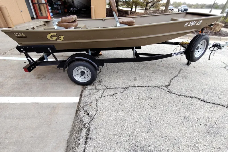 Slide: The Image of 2022 G3 1236 boat on trailer in parking lot. - 2
