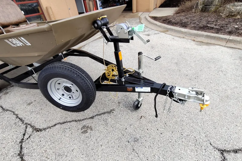 Slide: The Image of Trailer hitch and wheel assembly of a 2022 G3 model 1236 boat on pavement. - 4