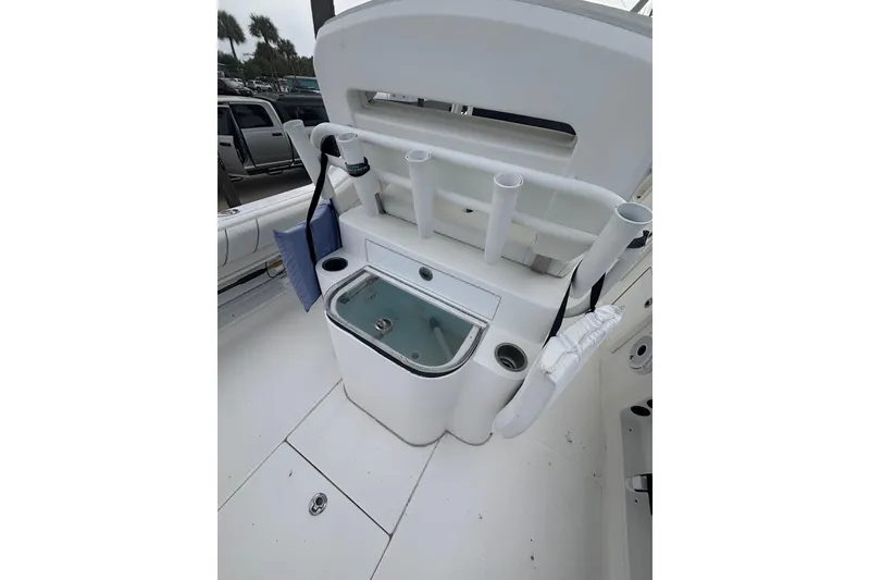 Slide: The Image of 2017 Buddy Davis 28 Center Console boat with rod holders and storage compartments. - 10