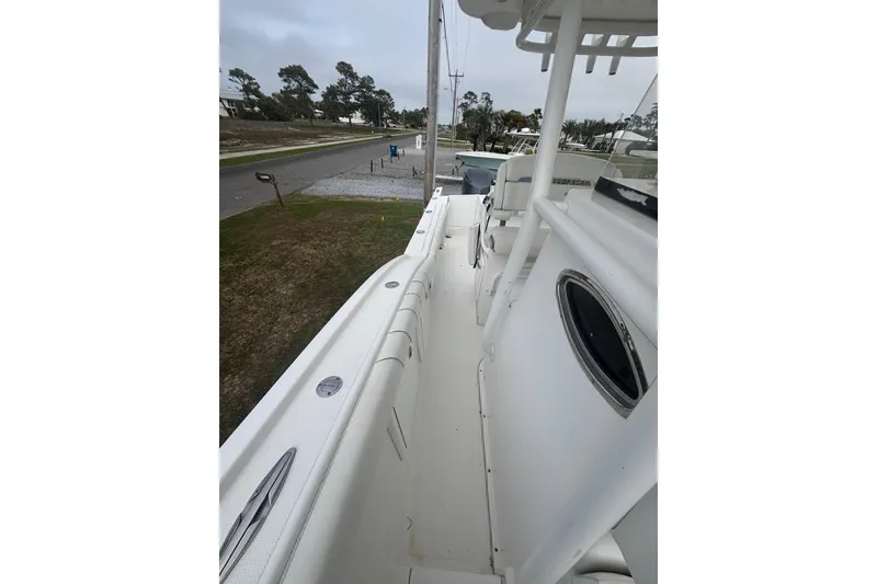 Slide: The Image of 2017 Buddy Davis 28 Center Console boat, side view, docked on a cloudy day. - 11