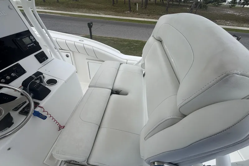 Slide: The Image of 2017 Buddy Davis 28 Center Console boat interior with white seating and control panel. - 12