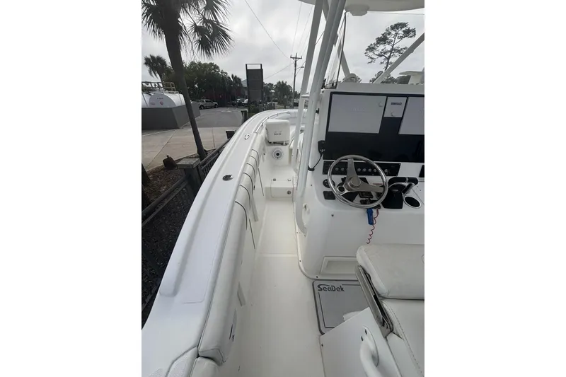 Slide: The Image of 2017 Buddy Davis 28 Center Console boat interior with steering wheel and seating. - 14
