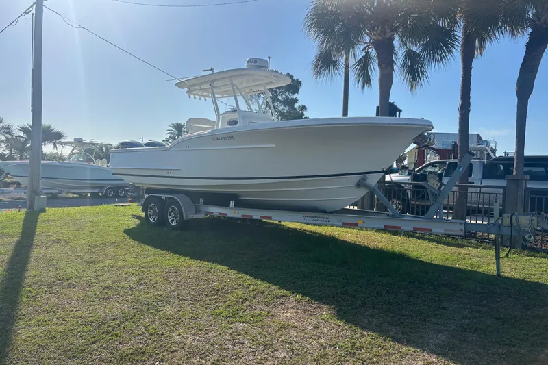 Slide: The Image of 2017 Buddy Davis 28 Center Console boat on trailer, parked under palm trees. - 3
