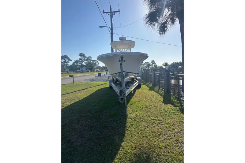 Slide: The Image of 2017 Buddy Davis 28 Center Console boat on trailer, parked on grassy roadside. - 4