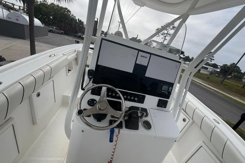 Slide: The Image of 2017 Buddy Davis 28 Center Console boat helm with Simrad displays and steering wheel. - 6