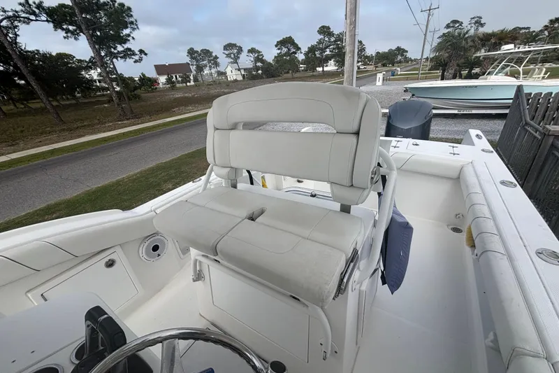 Slide: The Image of 2017 Buddy Davis 28 Center Console boat interior with cushioned seating and steering wheel. - 8