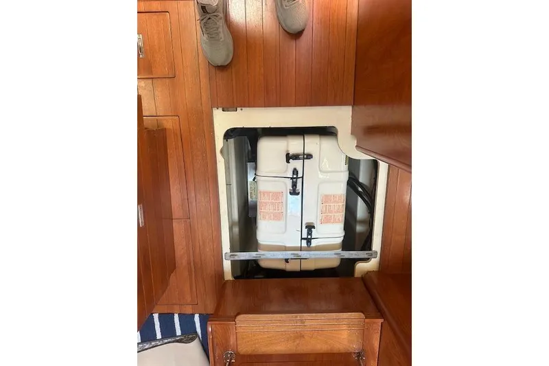 Slide: The Image of 2011 Hunter Aft Cockpit 50 interior with open floor hatch revealing storage compartment. - 15