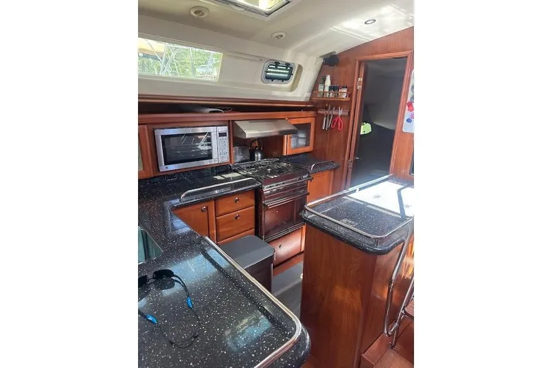 Slide: The Image of Luxurious 2011 Hunter Aft Cockpit 50 yacht kitchen with modern appliances and wood cabinetry. - 17