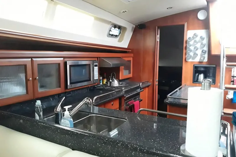 Slide: The Image of Luxurious 2011 Hunter Aft Cockpit 50 yacht kitchen with modern amenities and sleek design. - 18