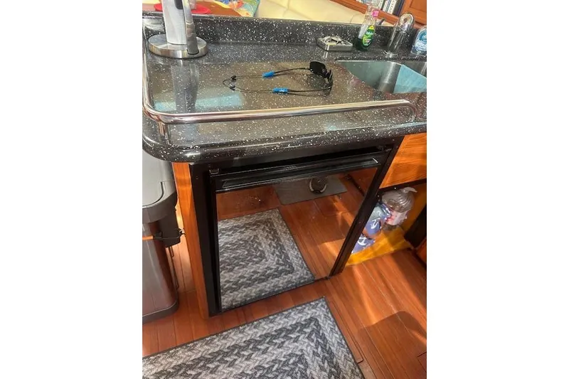 Slide: The Image of Hunter Aft Cockpit 50 yacht kitchen with black countertop and sink, 2011 model. - 20