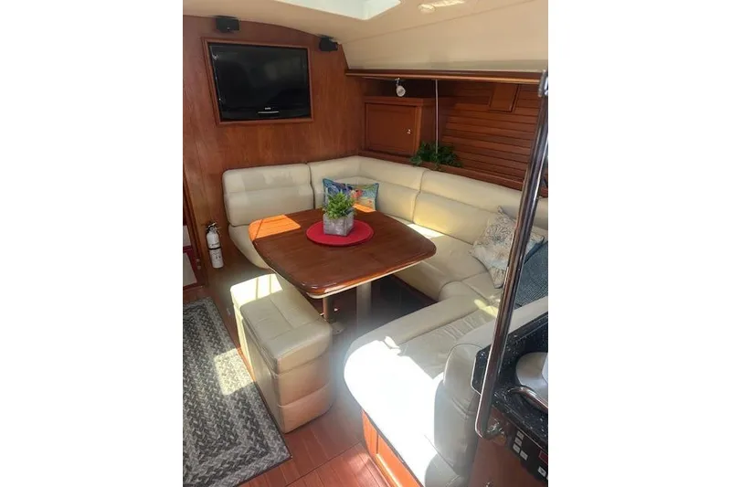 Slide: The Image of Luxurious interior of 2011 Hunter Aft Cockpit 50 yacht with cozy seating and table. - 23